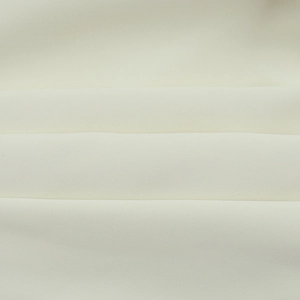 Macro detail of the creamy white twill fabric texture showing soft weave and fiber