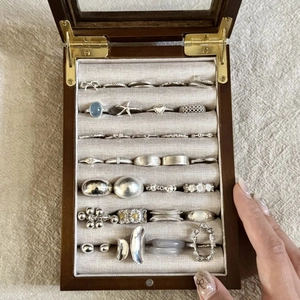 Minimalist S925 sterling silver rings displayed in a luxury wooden jewelry storage box