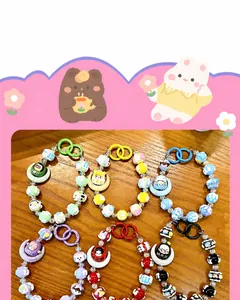 Detailed view of colorful beaded keychains with crescent moon charms and cartoon characters