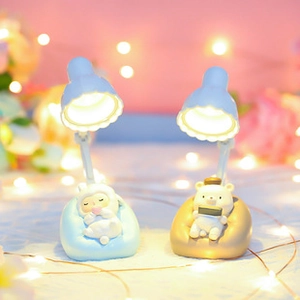 Miniature blue and brown animal night lamps with warm glow on a dreamy background