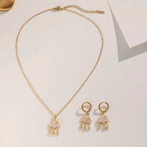 Close-up of golden cloud pendants with pink stone inlay and cubic zirconia charms