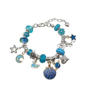 Blue theme DIY charm bracelet set with ocean pendants and crystal beads on white background