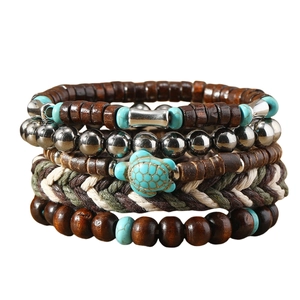 Detail shot of multi-layer beaded bracelet featuring a turtle pendant and turquoise accents