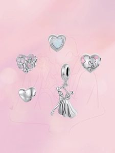 Detailed view of S925 sterling silver heart charms with opal and enamel craftsmanship
