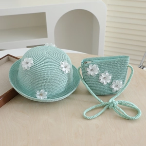 Detail of mint green straw hat and bag set with 3D white flowers for toddler girls