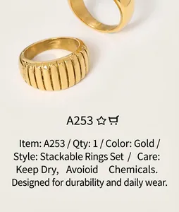 Close-up of vintage golden croissant rings with pleated texture on a magazine