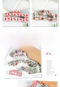 Detail of Christmas reindeer and holly patterns on large rectangle hair claw clips
