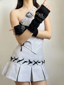 Detail of Y2K punk fingerless arm warmers with metal heart buckles and black knit texture