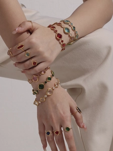 Detail von 18k vergoldeten Armbändern und Ringen mit bunten Zirkoniasteinen besetzt