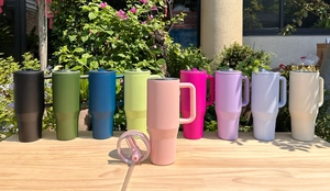 Outdoor display of 40oz insulated tumblers with handles and straws in multiple colors