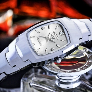 Macro shot of silver square dial quartz watch with rhinestones and stainless steel strap
