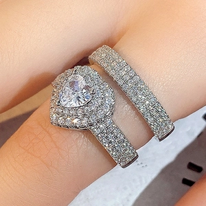 Macro view of a luxury heart-shaped zircon bridal ring set with shimmering silver finish