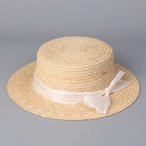 Detailed top view of raffia boater hat with a white sheer silk bow decoration