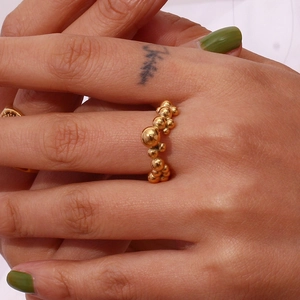 Detail of 18K gold plated titanium steel ring with unique metal bead cluster design