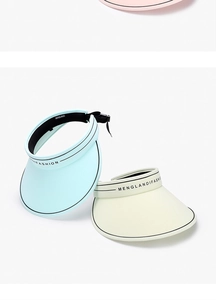 Detail view of stylish ice silk sun visor hats in light blue and cream colors