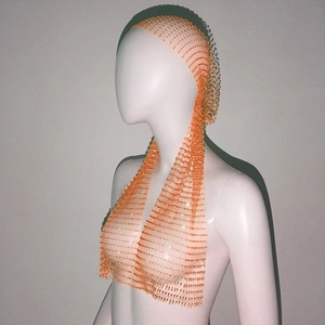 Detail of orange rhinestone fishnet headscarf and halter top set with sparkling mesh