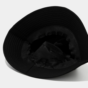 Detail shot of black bucket hat showing the adjustable drawstring and inner lining quality