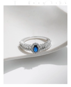 Detail view of oval sapphire style ring with sparkling micro-pave cubic zirconia stones