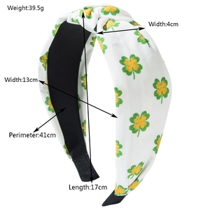 Knotted fabric headband featuring green clover print with size and weight dimensions