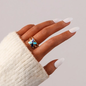 Gold hollow open ring with blue enamel clover design on multi-layer stainless steel bands