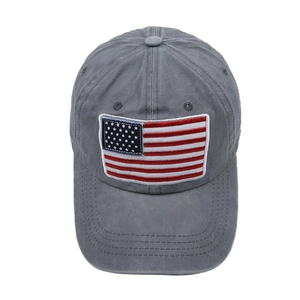 Close-up of American flag patch and washed texture on dark gray cotton baseball cap