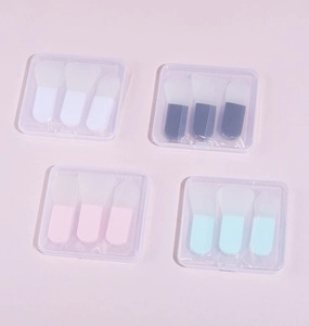 Set of four silicone face mask brushes in various colors with portable storage cases