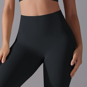 Close-up showing the high-waist fit and tummy control fabric of black yoga leggings