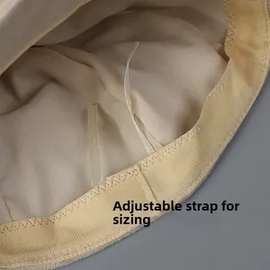 Detail of cotton newsboy hat inner lining featuring adjustable drawstring and sweatband