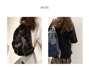 Detail of Korean style patchwork denim backpack showing black and blue color options