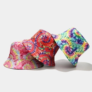 Detailed close-up showing three tie-dye bucket hats in vibrant rainbow color combinations