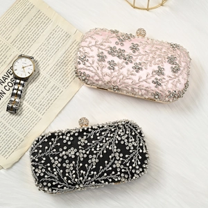 Close-up of luxury pink and black evening clutch bags with hand-beaded rhinestones