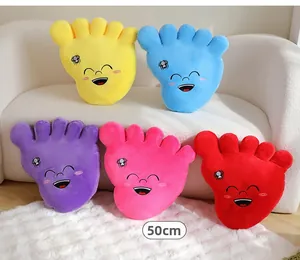 Group of 50cm soft plush big foot pillows in various colors displayed on a white sofa