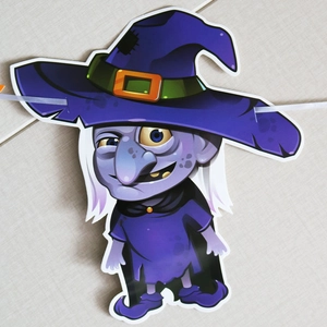 Detail of purple paper witch cutout for Halloween party banner with pre-punched holes