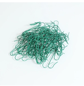 Close-up of numerous green S-shaped metal wire hooks for Christmas tree decorations