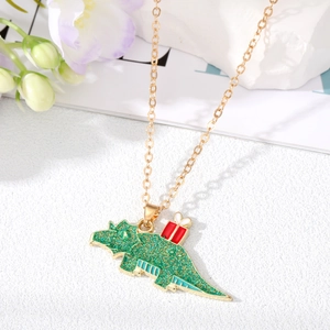 Golden necklace with a green Christmas dinosaur pendant and red gift on white background