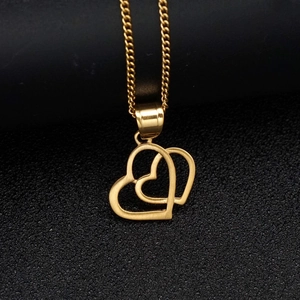 Polished double heart pendant necklace in 18K gold finish on a black textured stand