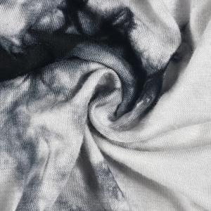 Détail macro du tissu en maille tie-dye gris et blanc pour une robe courte