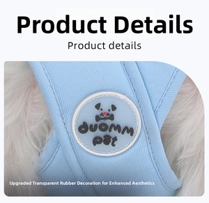 Detail of light blue dog harness featuring a circular transparent rubber decorative buckle