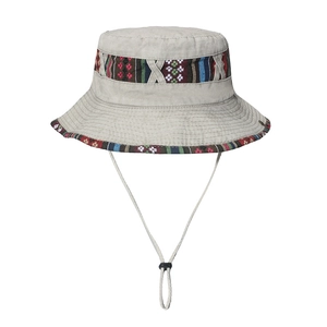 Close-up of beige cotton bucket hat featuring ethnic woven trim and adjustable wind rope