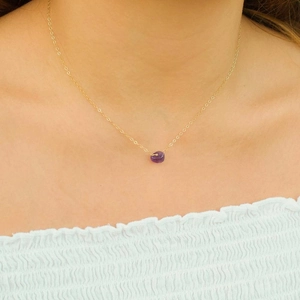 Golden cross chain necklace with an irregular purple natural crystal stone pendant
