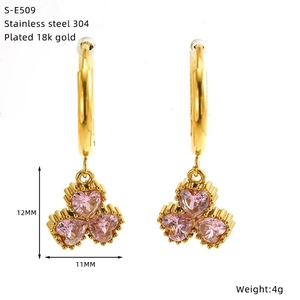 Detail von 18K vergoldeten Edelstahl-Ohrringen mit drei rosa herzförmigen Steinen