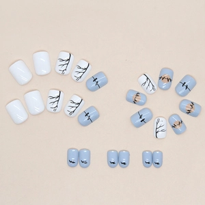 Short blue sunset press-on nails featuring bird silhouettes and hand-painted branches