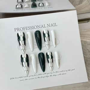 Handmade stiletto press-on nails with luxury green and white snake skin art design