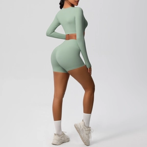 Side view of matte light green yoga set with long sleeve crop top and high waist shorts