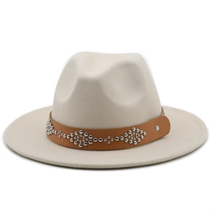 Detail of beige fedora hat featuring a brown leather band with silver metal rivets