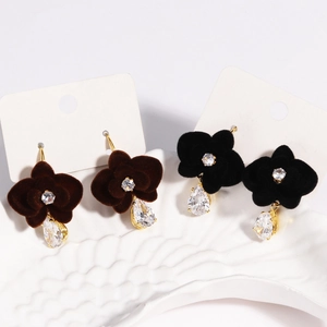Detail of red and black floral tassel earrings with velvet texture and crystal drops