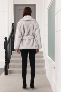 Back view of a grey faux fur coat with waist belt and textured plush fabric details
