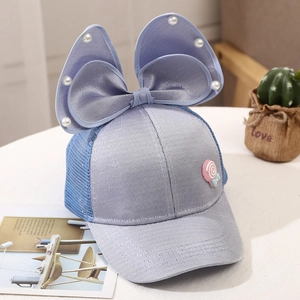 Detail of light blue girls' baseball cap with mesh, large bow, and pearl accents