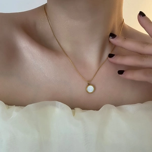 18K gold plated necklace with white mother of pearl pendant worn on model skin