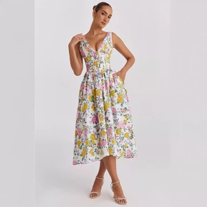 Detailed view of white sleeveless midi dress with vibrant yellow floral print and V-neckline